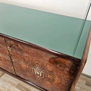 Mid-century mahogany buffet with teal glass and compartments with a drawer.