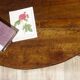 Walnut drop-leaf table with honey spoon legs.