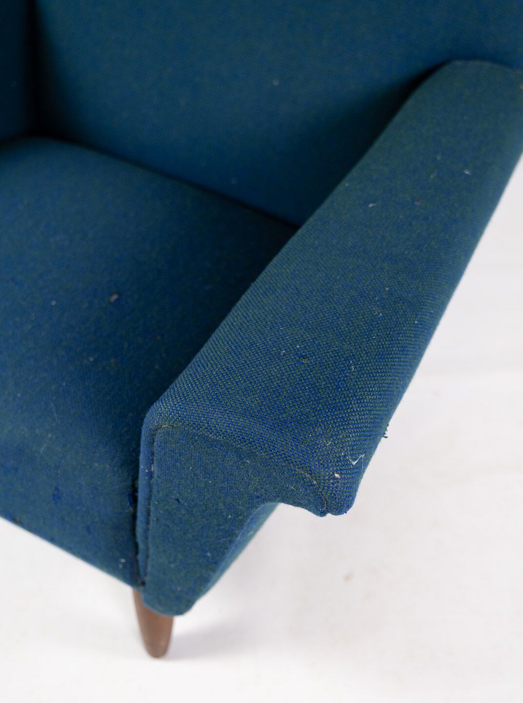 Armchair upholstered with dark blue wool fabric and legs in dark wood, of danish design, 1960s