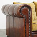 Luxurious and spacious two-seater sheepskin sofa of top quality with fabric cushions