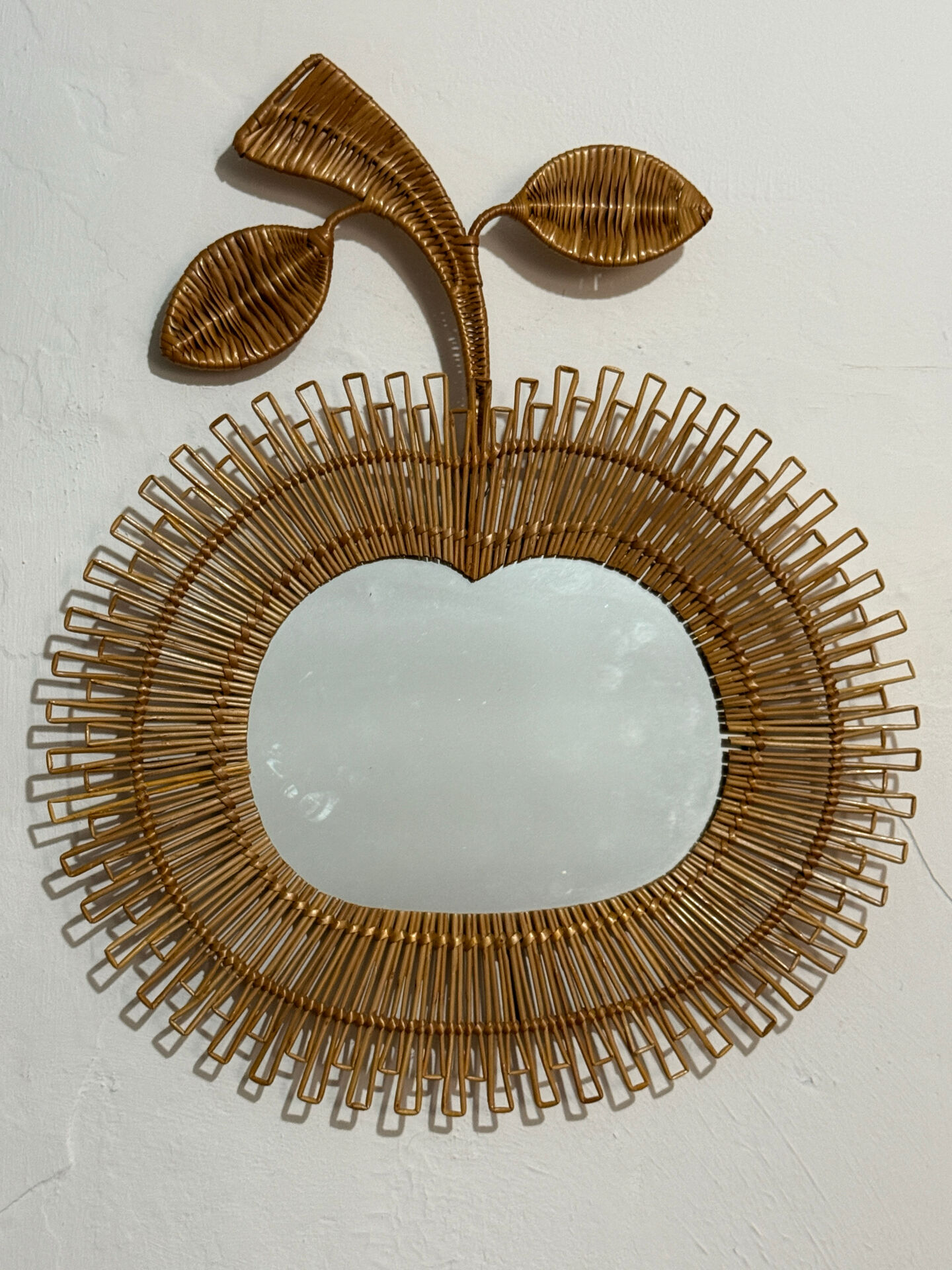 Rattan mirror in the shape of an apple from the 1960s Italy.