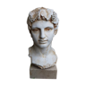 bust of young man of antiquity in plaster on marble pedestal