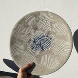 Round ethnic handmade fish dish