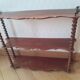 Turned wooden wall shelf