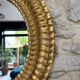 Pair of antique oval mirrors gilded with gold leaf and mercury.