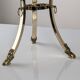Neoclassical side table in brass and bevelled glass with ram's heads, 1970s.