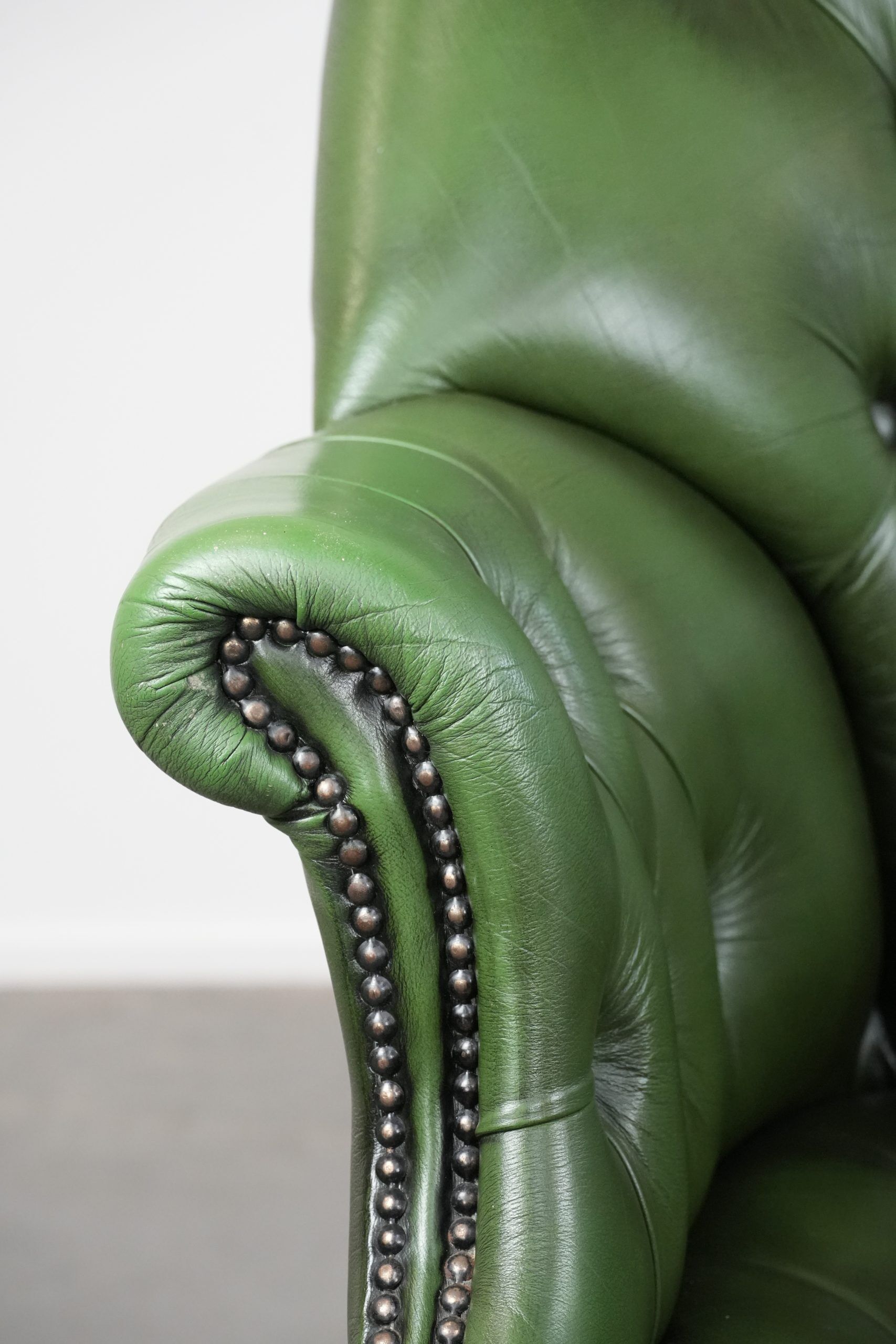 Large green cowhide Chesterfield office chair in English style on wheels