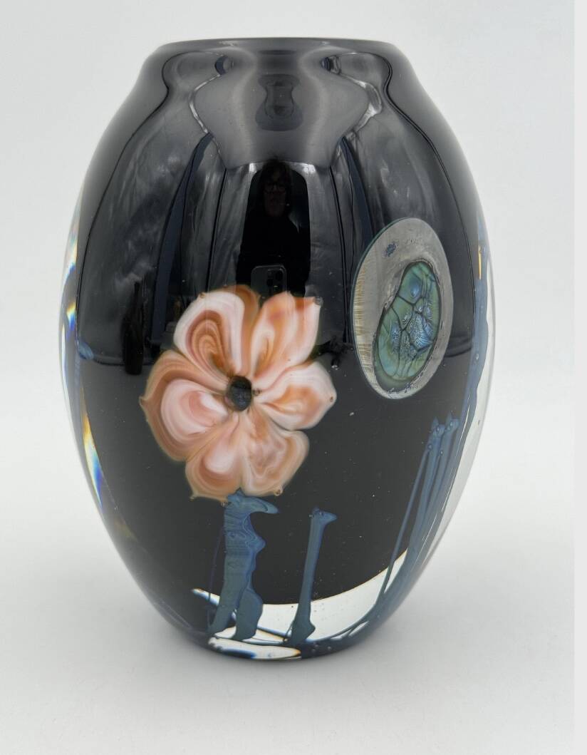 Double-lined blown glass vase with flower inclusions.