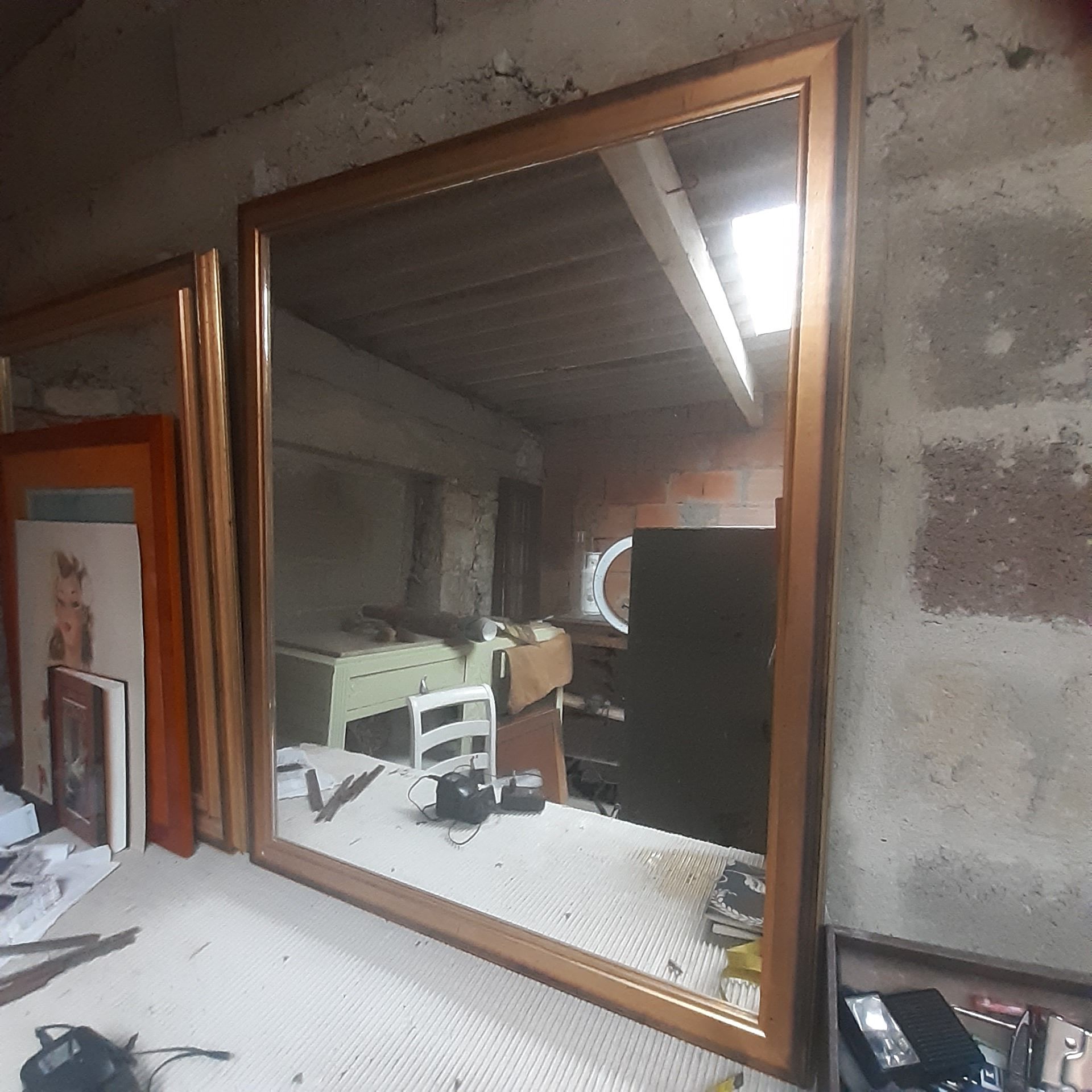 Old mirror of period handmade by cabinetmaking and decorated with gold leaf