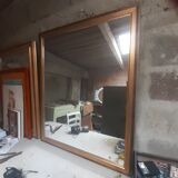 Old mirror of period handmade by cabinetmaking and decorated with gold leaf