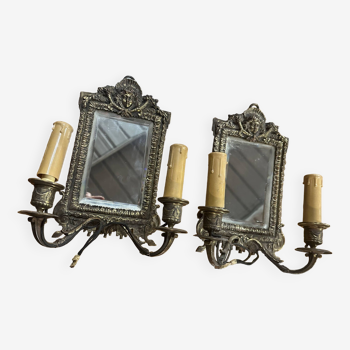 Pair of bronze wall lights decorated with a mirror