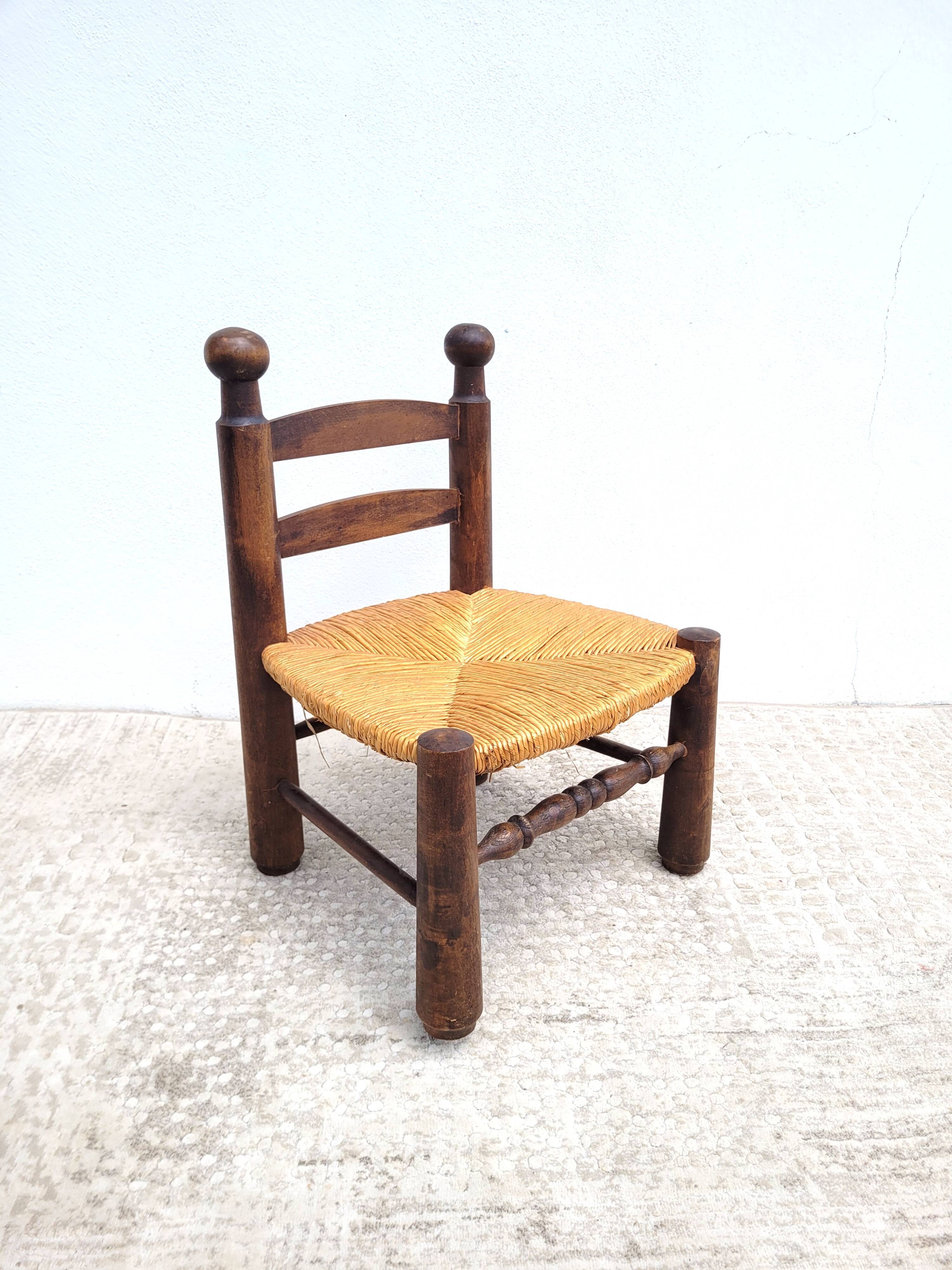 Low chair in turned wood and straw