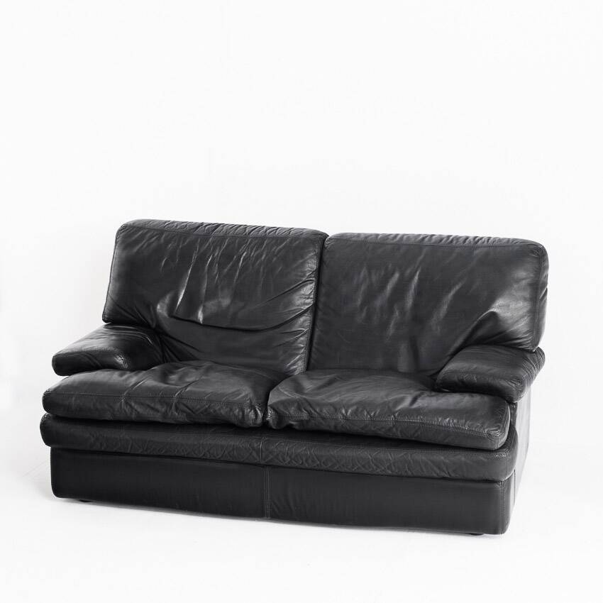 Black leather two-seater sofa. Roche Bobois edition. France, 1980s.