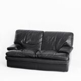 Black leather two-seater sofa. Roche Bobois edition. France, 1980s.