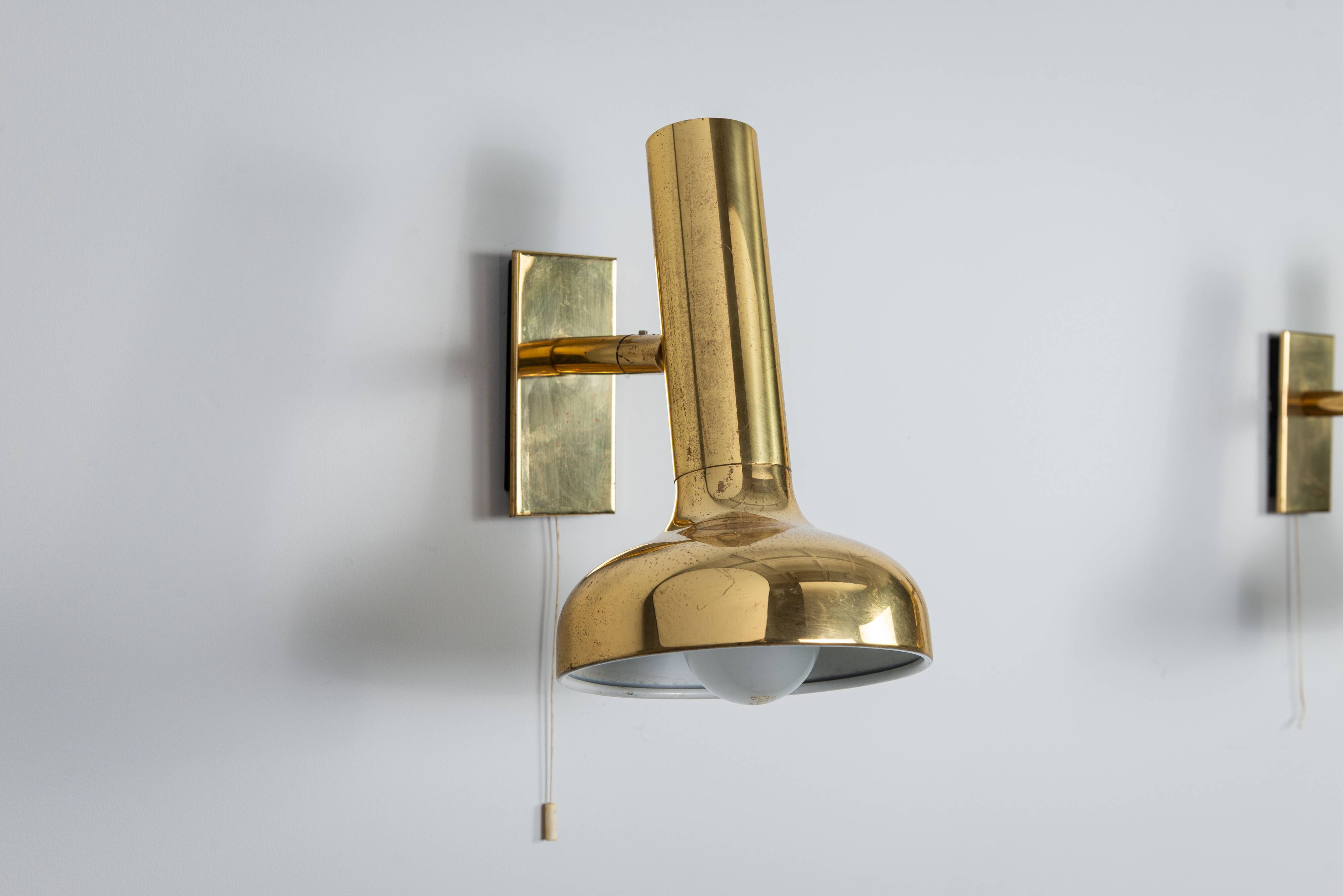 Set of three brass adjustable wall lamps