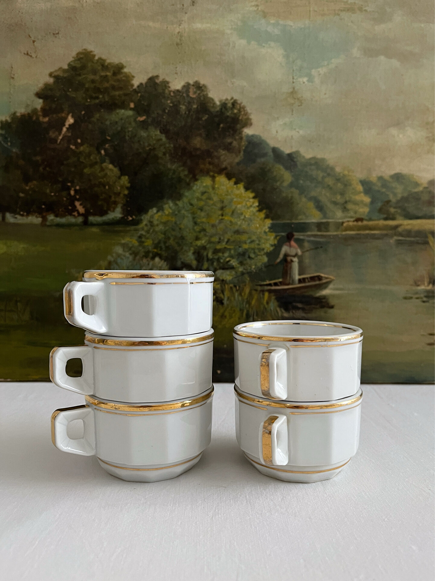 5 vintage porcelain bistro coffee cups from Paris with gold trim.