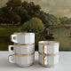 5 vintage porcelain bistro coffee cups from Paris with gold trim.
