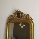 Late 19th century gilded mirror with decorated pediment. 125x70.