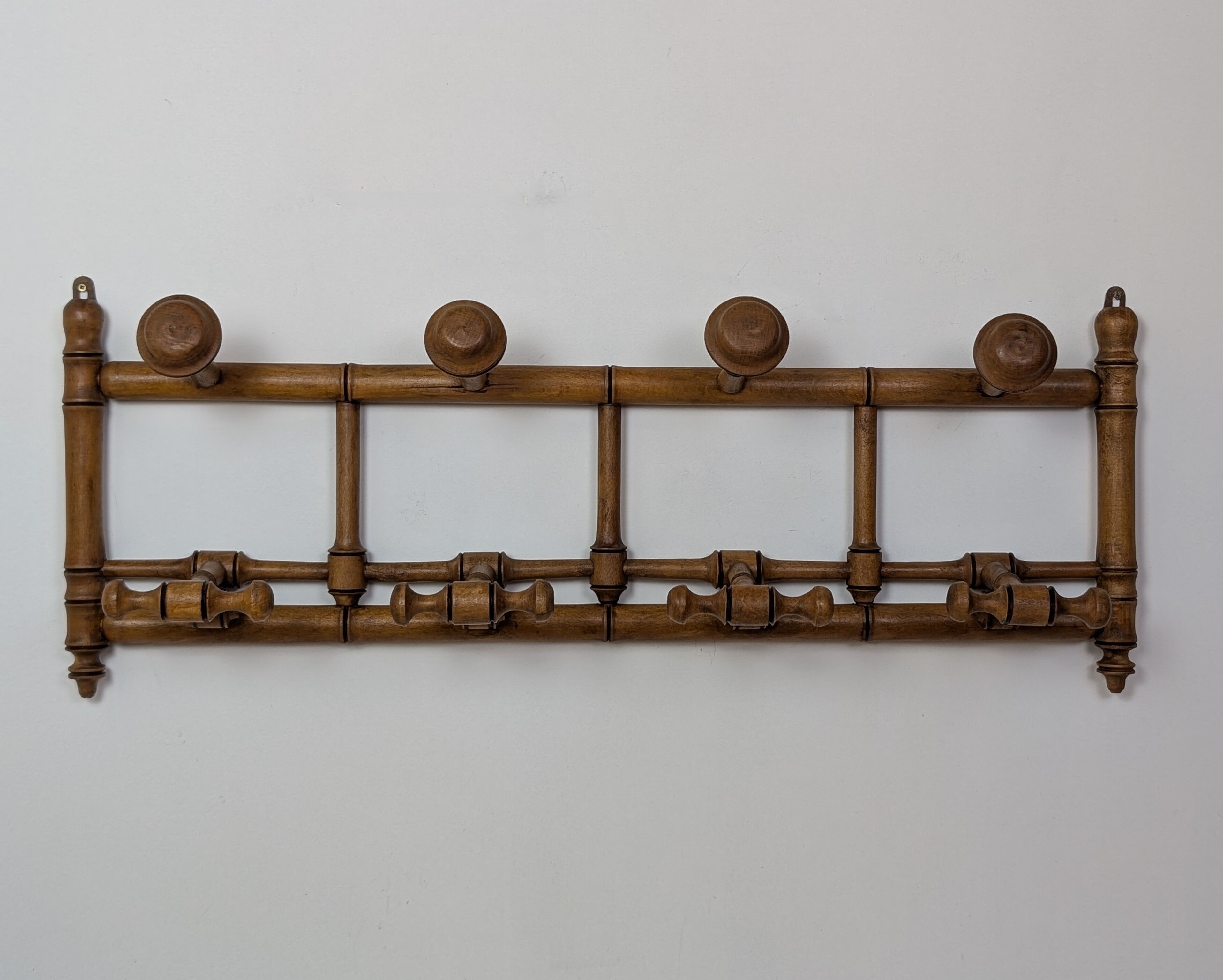Wall-mounted coat rack made of turned wood