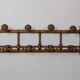 Wall-mounted coat rack made of turned wood