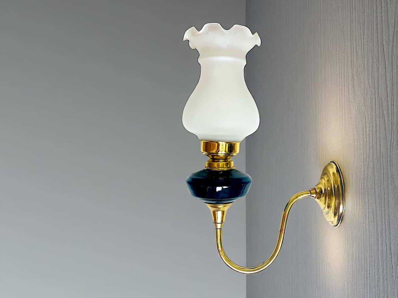 Brass wall sconce with frosted glass tulip lampshade