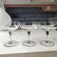Set of 6 Baccarat-style champagne glasses. Stylized grape cluster decoration.