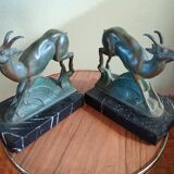 Pair - Chamois metal bookends with green patina & black marble base