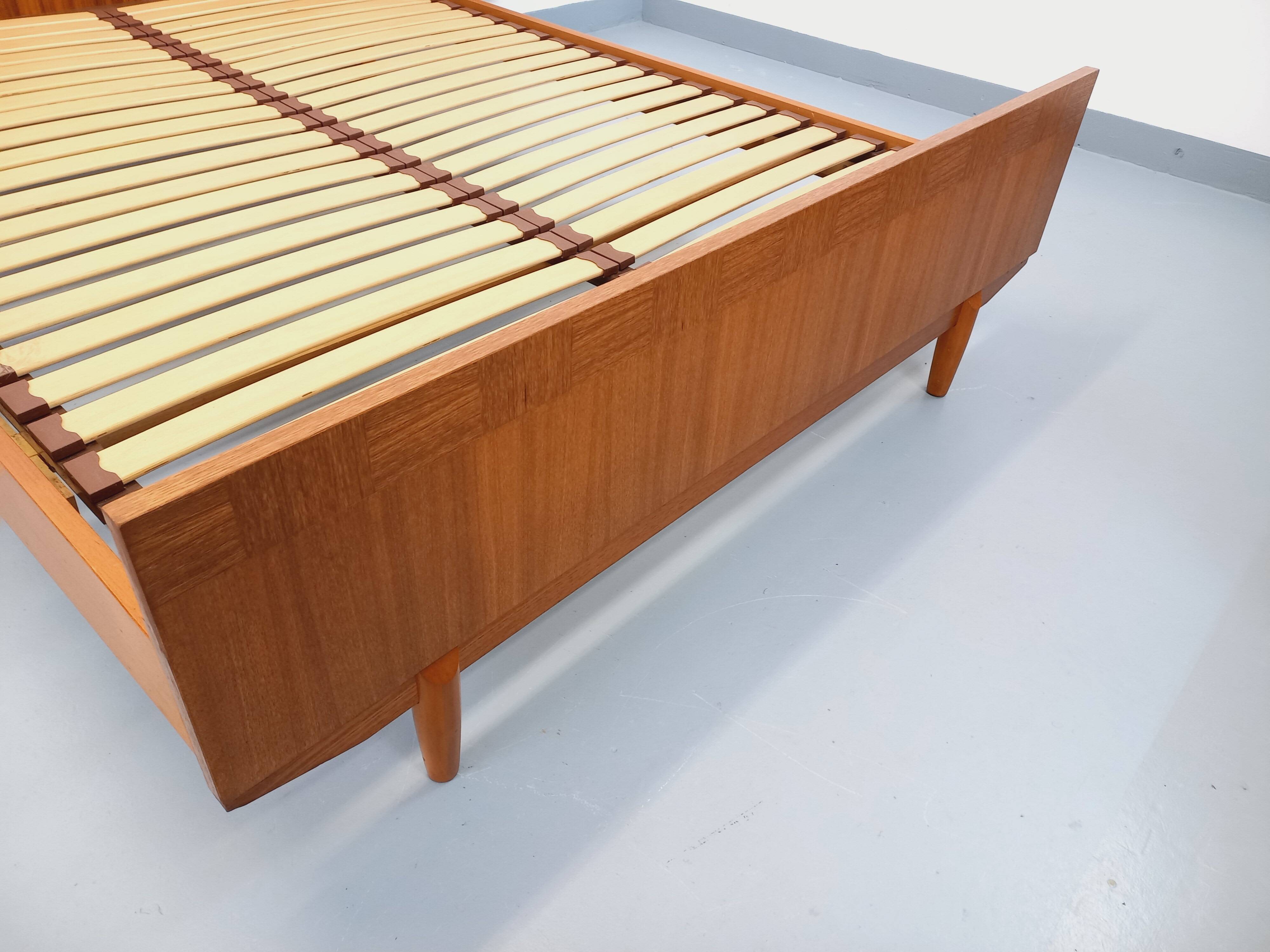Double bed vintage Scandinavian in teak from the 1960s with integrated bedside tables.