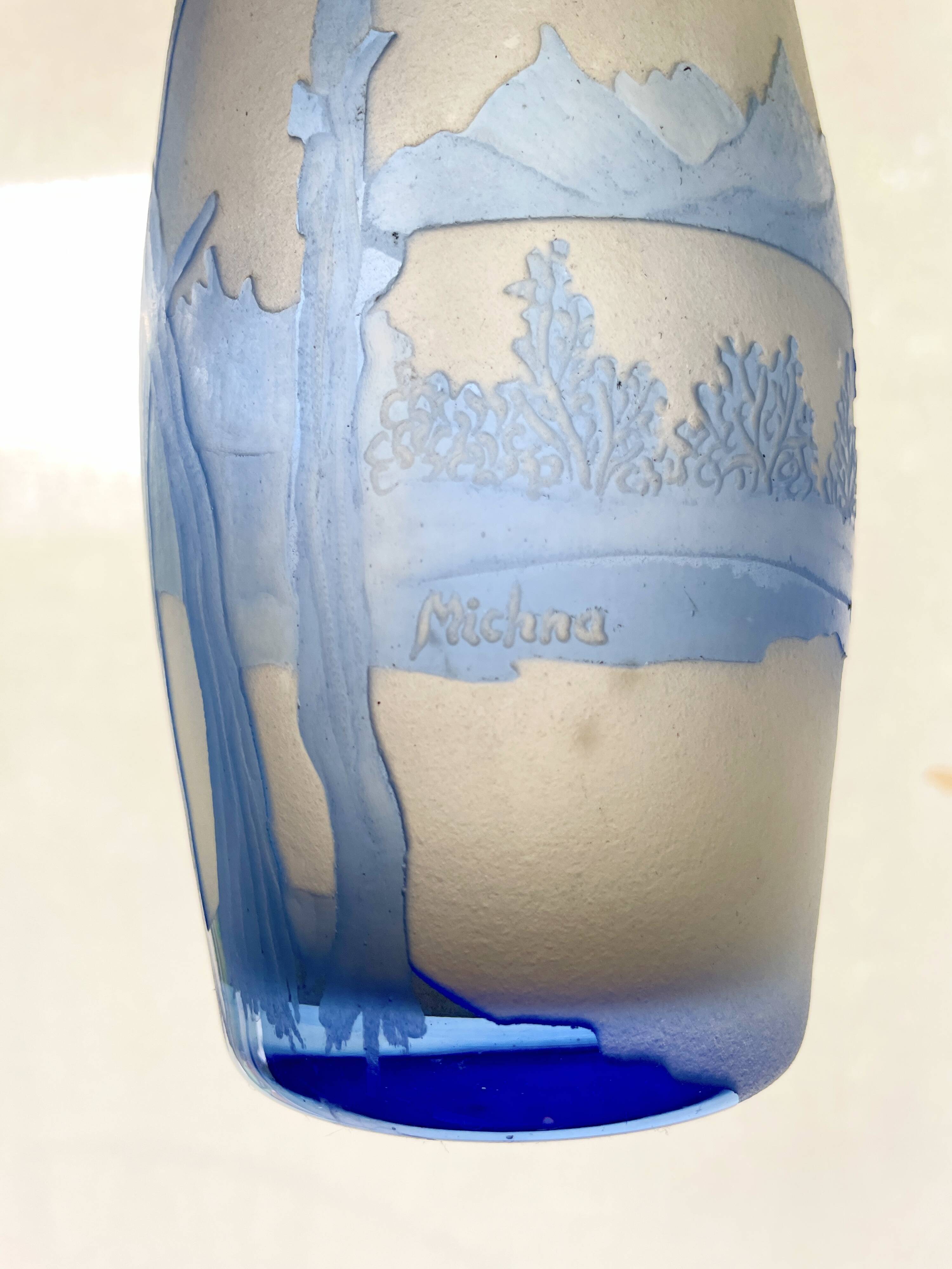 Transparent vase with a blue pattern featuring trees, signed MICHNA.