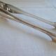 Christofle Silver-plated metal sugar tongs with crossed ribbon bow design