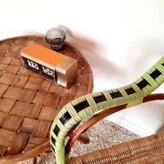 1950s 60s rattan armchair with green apple and black piping.