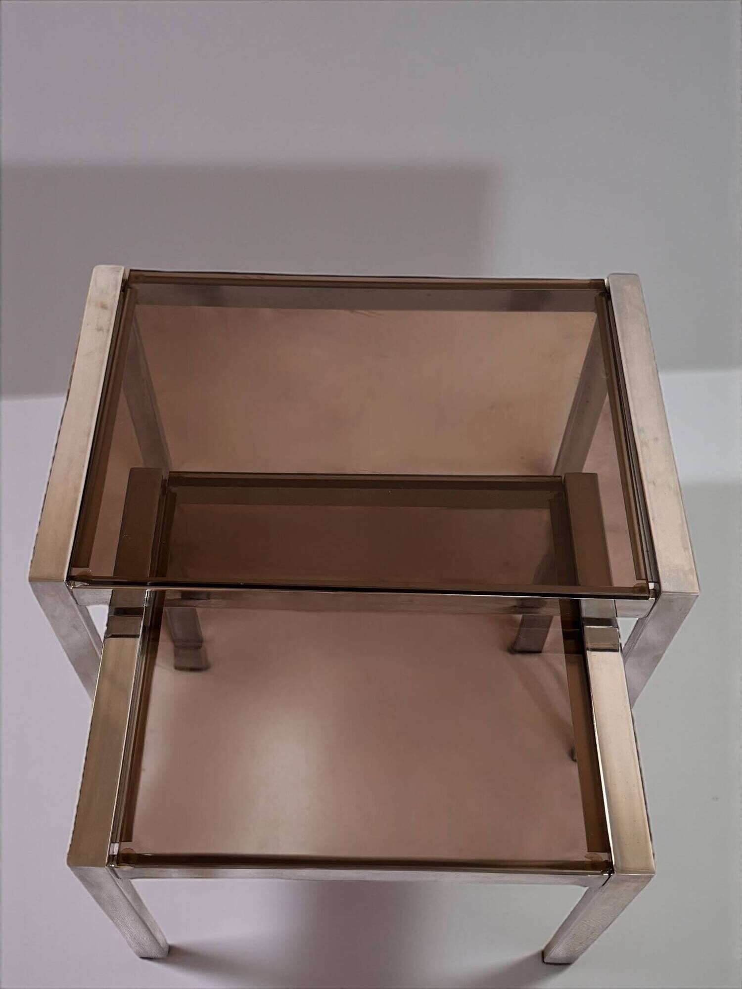 Vintage 1970s nesting tables in chrome and smoked glass, mid-century modernist style