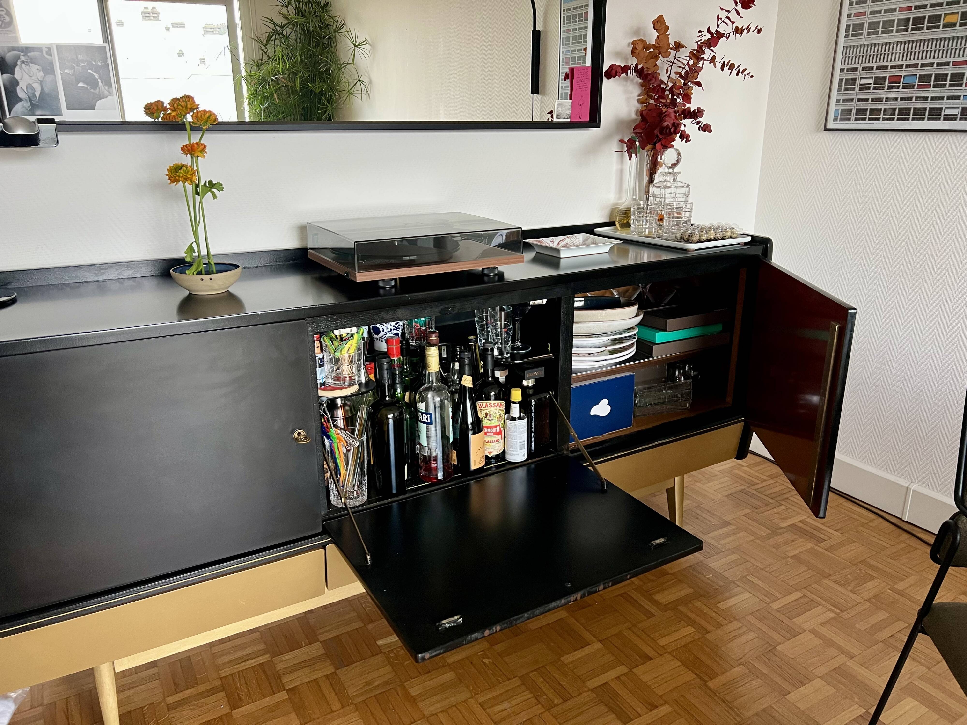 Black buffet cabinet including a bar and 3 drawers.
