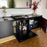 Black buffet cabinet including a bar and 3 drawers.