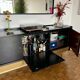 Black buffet cabinet including a bar and 3 drawers.