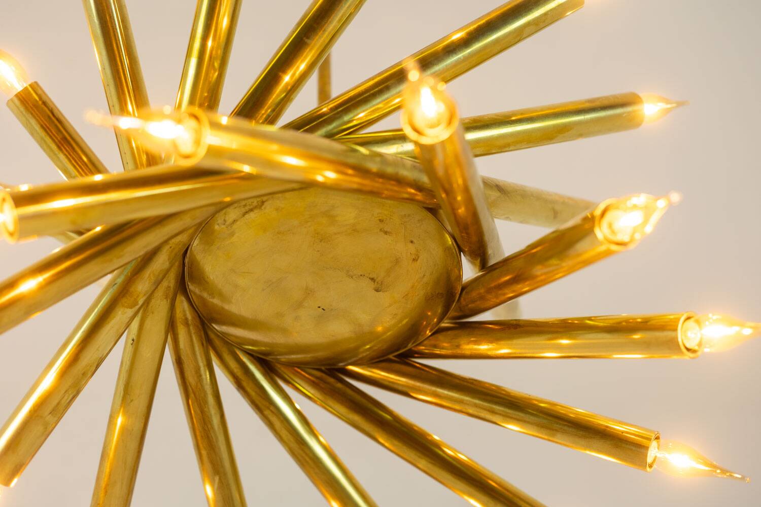 Pair of 24-light patinated brass chandeliers. 1980s.
