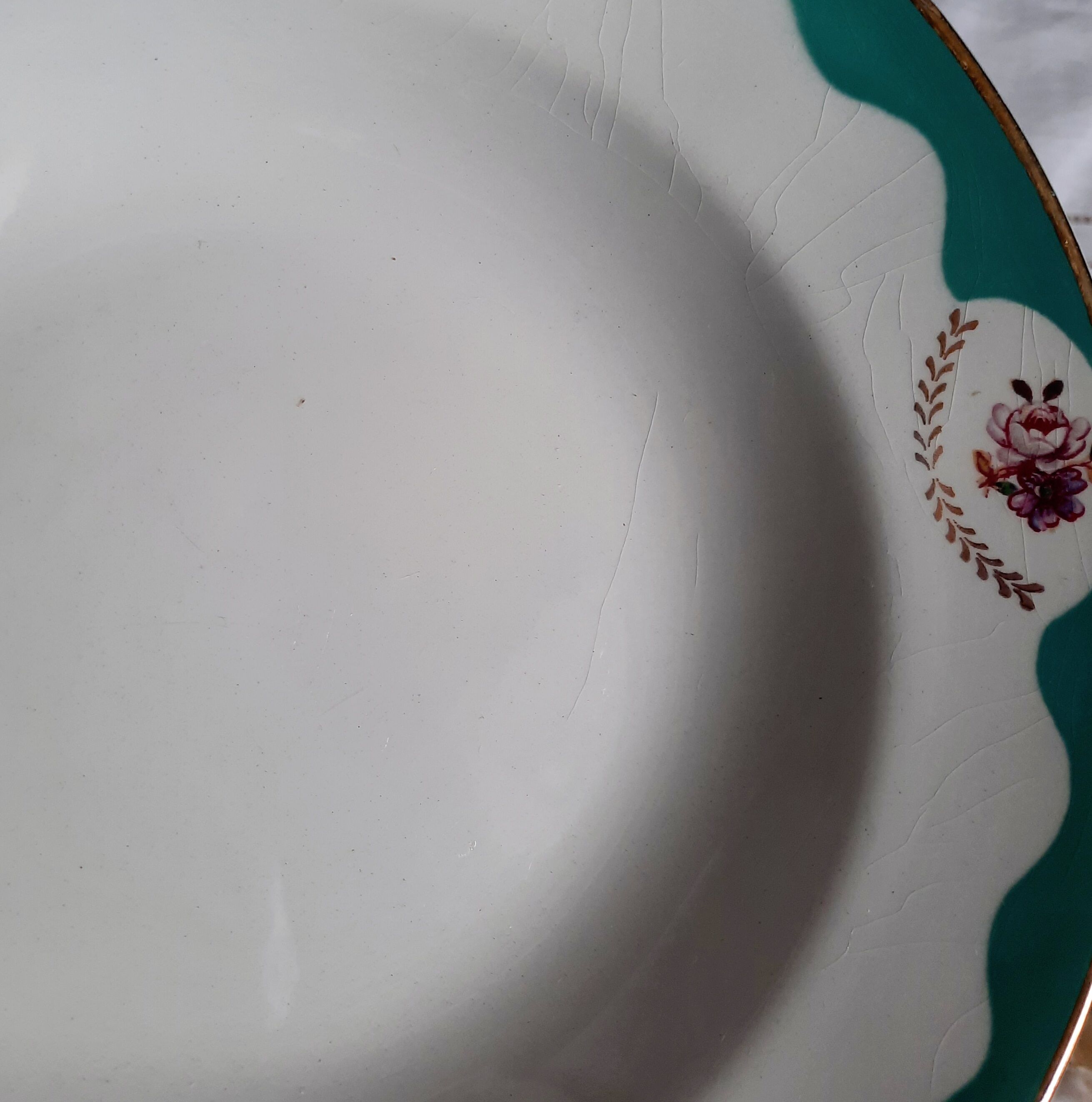 Old hollow plates mismatched in earthenware with gilded edges