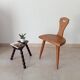 Low brutalist tripod chair in solid oak from the 1960s.