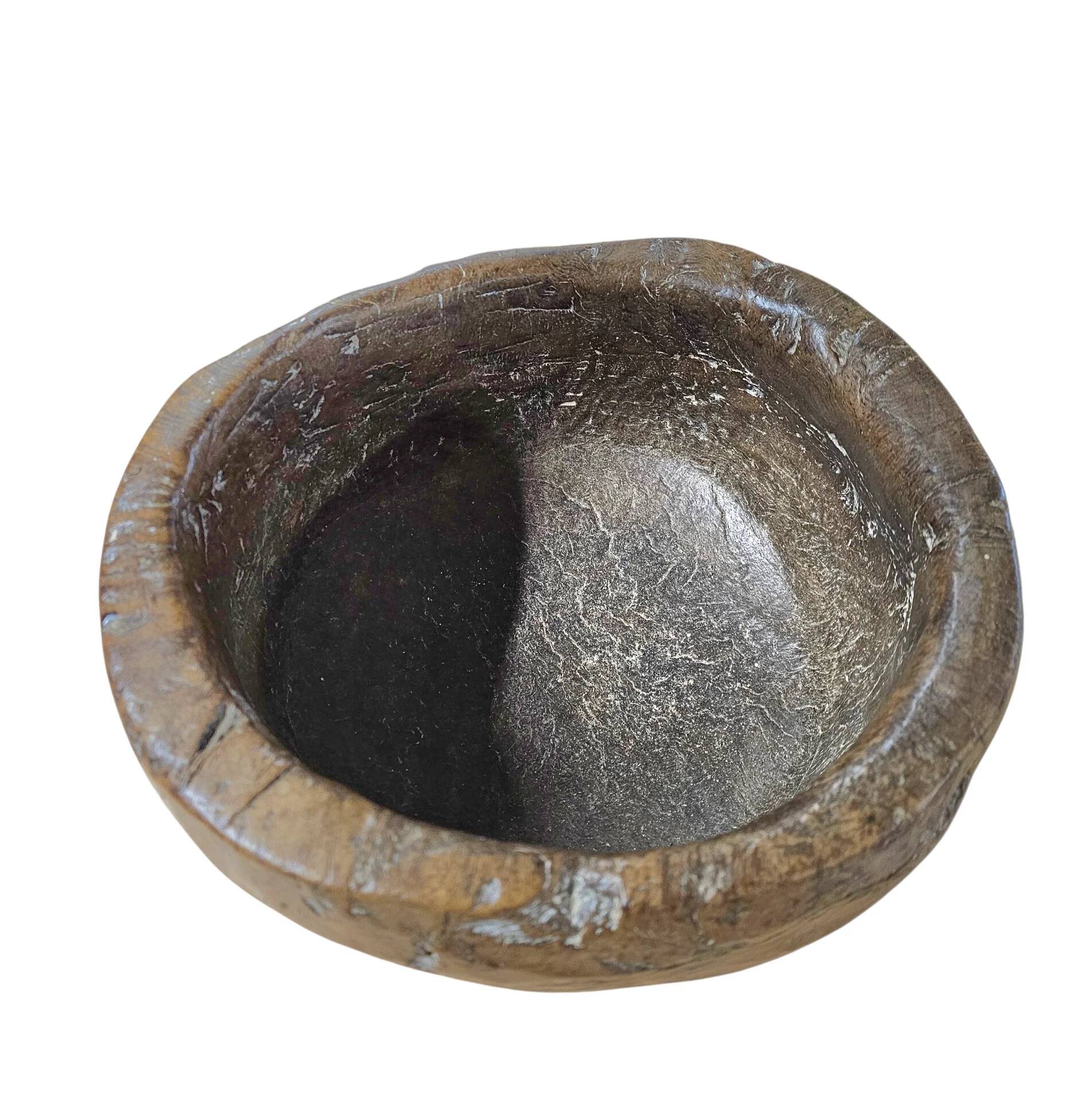 A substantial hand-hewn wooden bowl carved from a single burl section