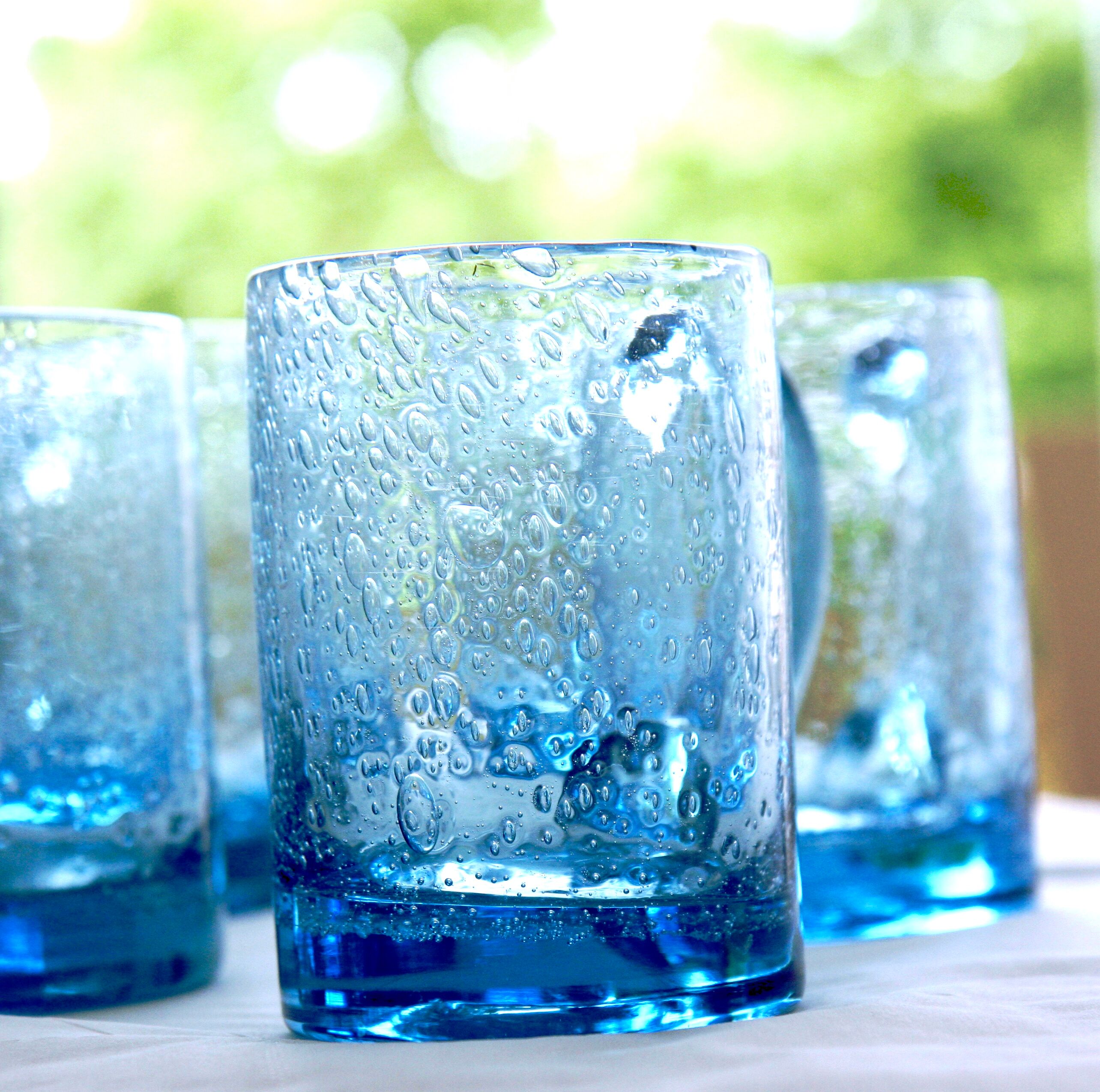 Four Biot glass mugs blue bubbled glass