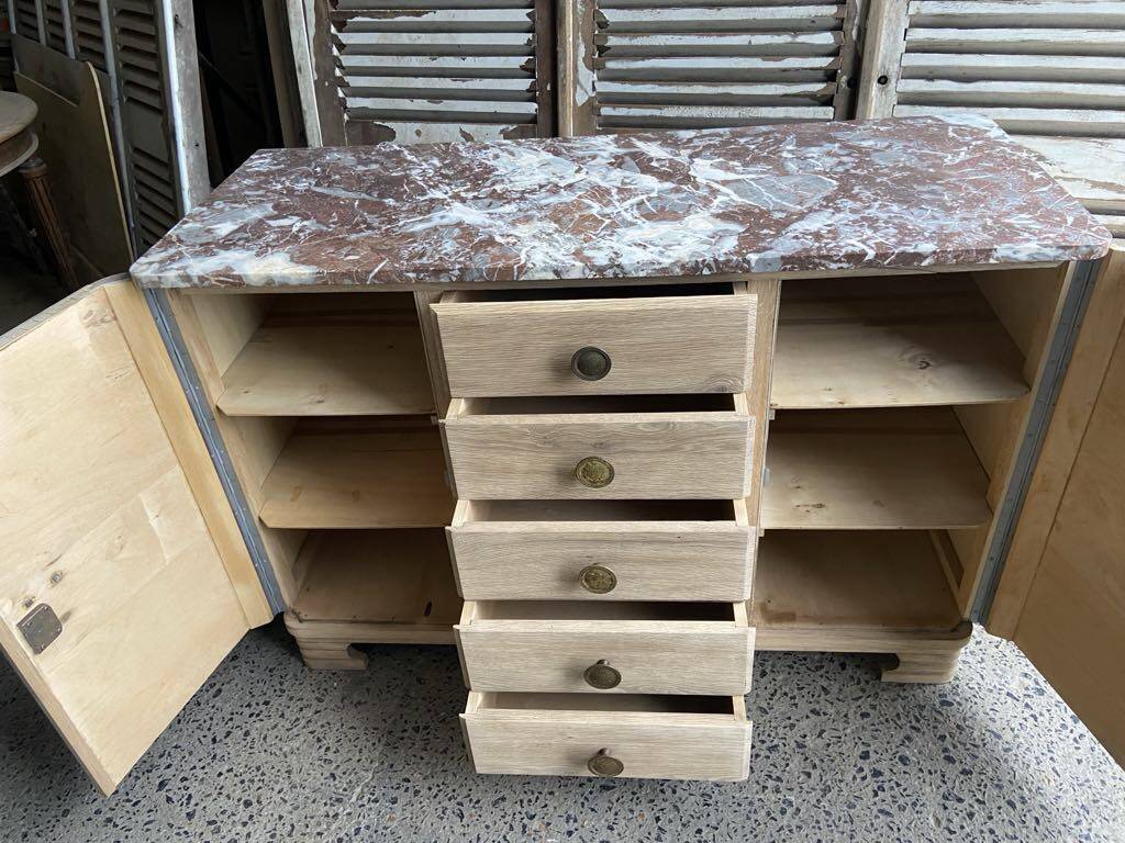 Raw wood chest of drawers with marble top