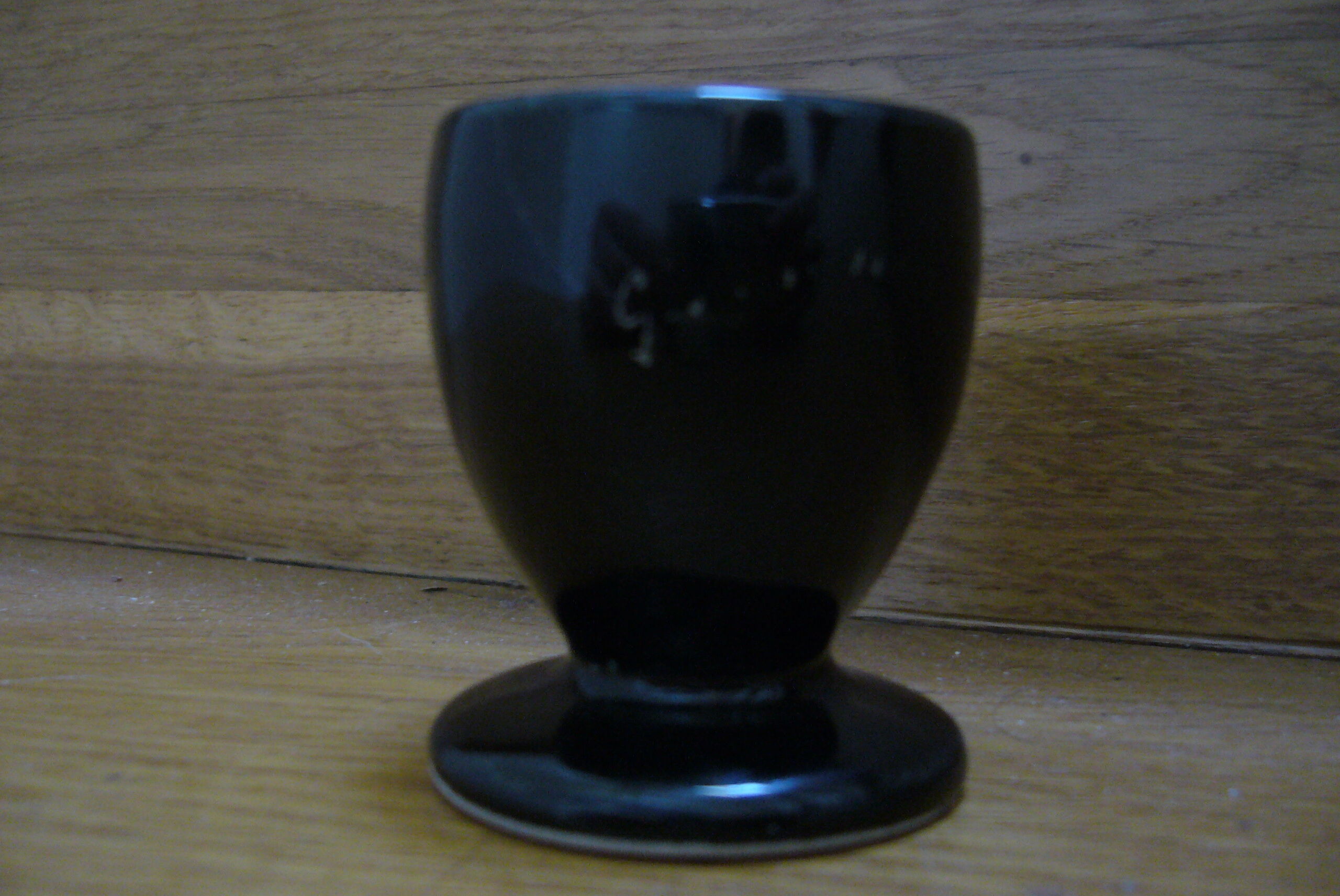 Black egg cup with hand-painted floral decoration