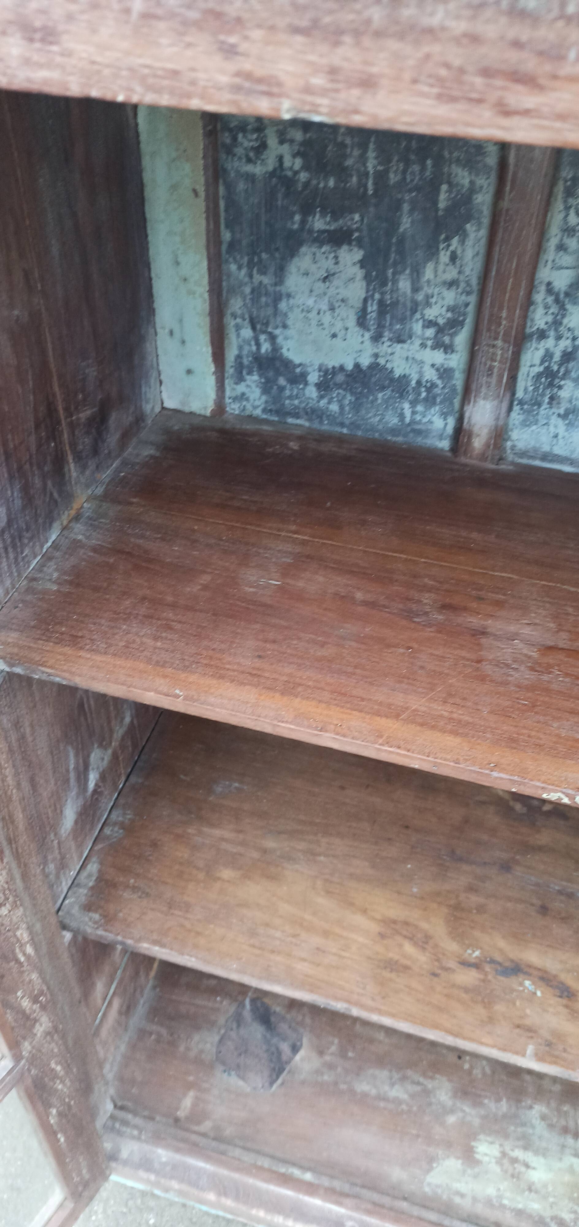 Old glazed wooden cabinet with metal bottom