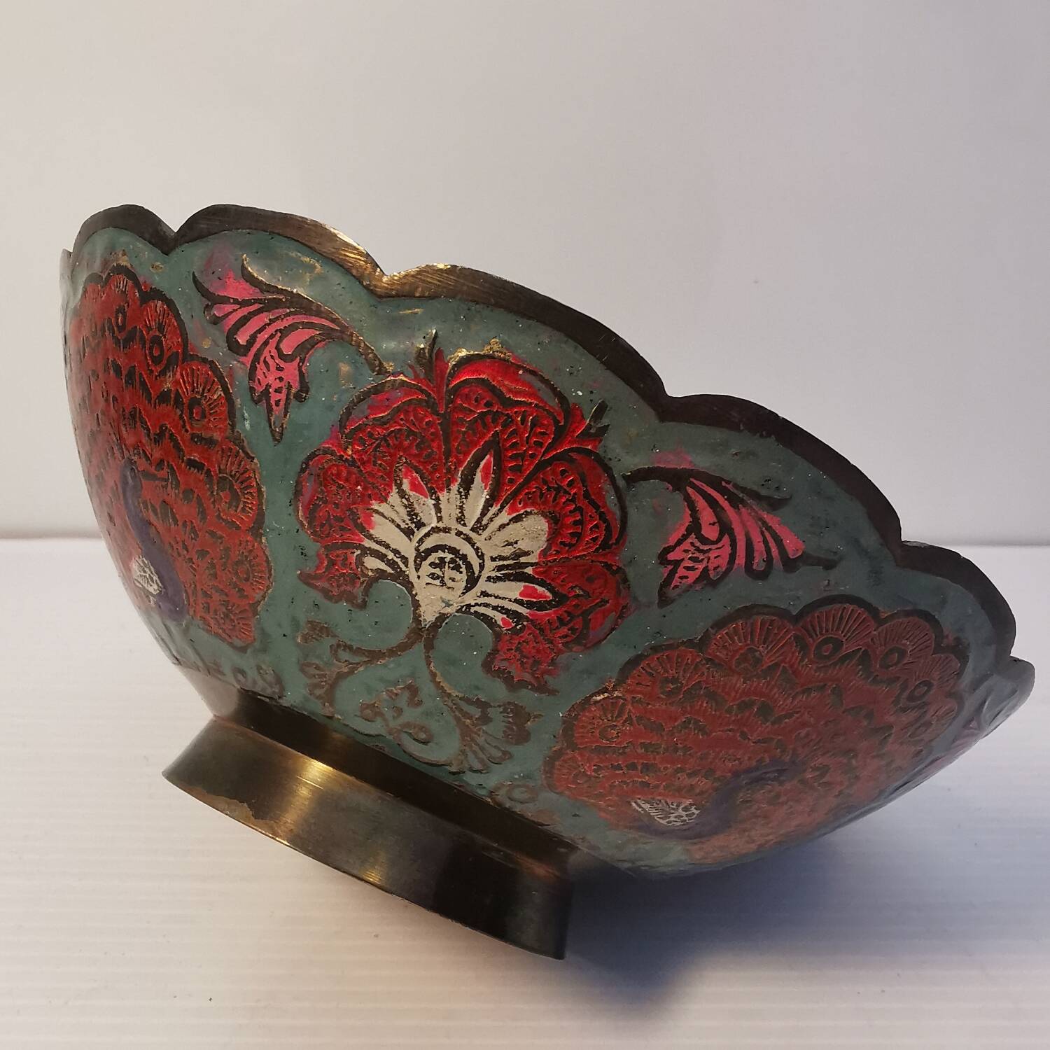 Old Indian brass bowl with peacock decoration