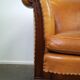 Unique old set of 2 club armchairs and a couch in cognac-colored leather with wheels