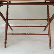 Vintage folding table with turned legs.