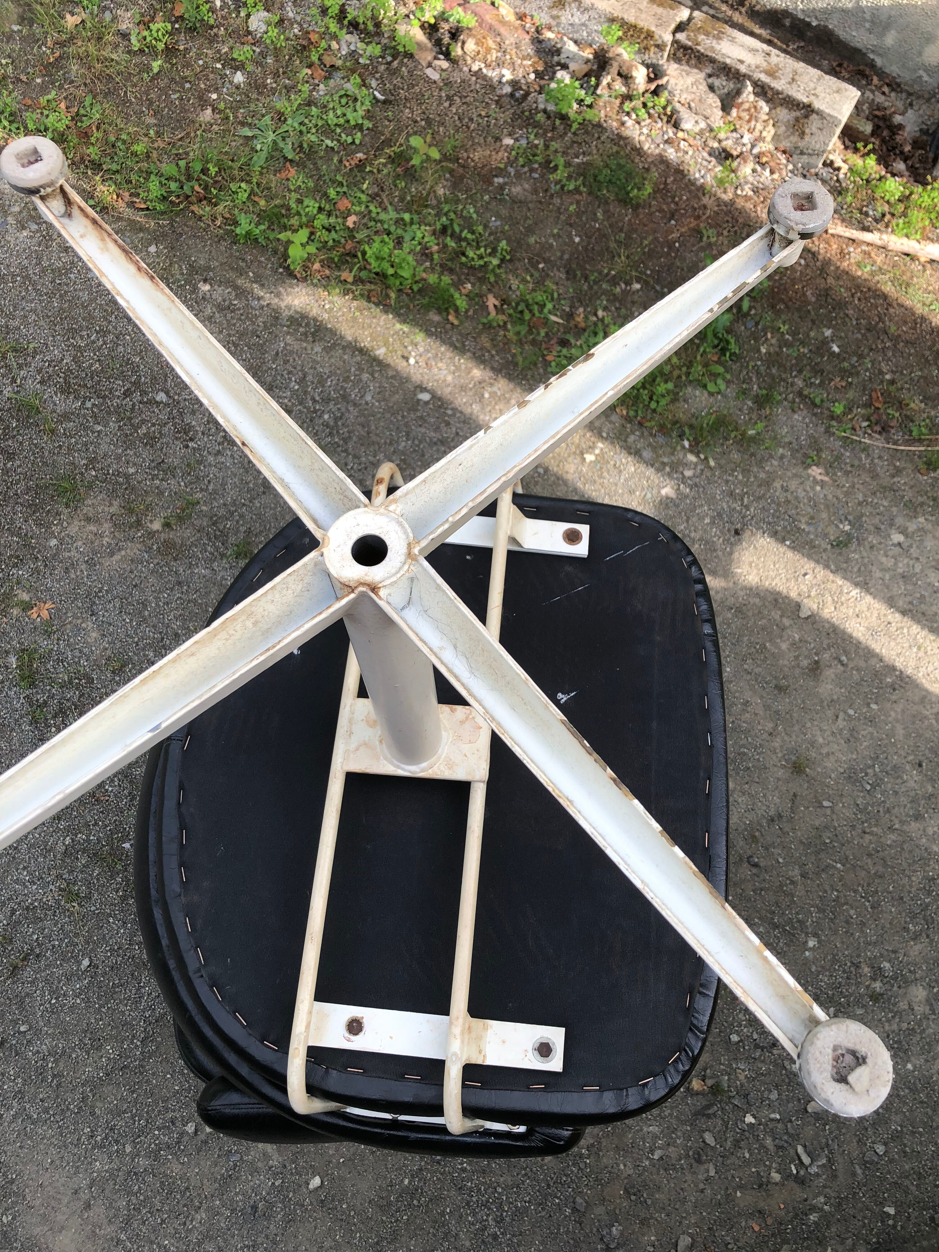 Pair of vintage armchairs in black skai with metal legs.