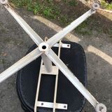 Pair of vintage armchairs in black skai with metal legs.