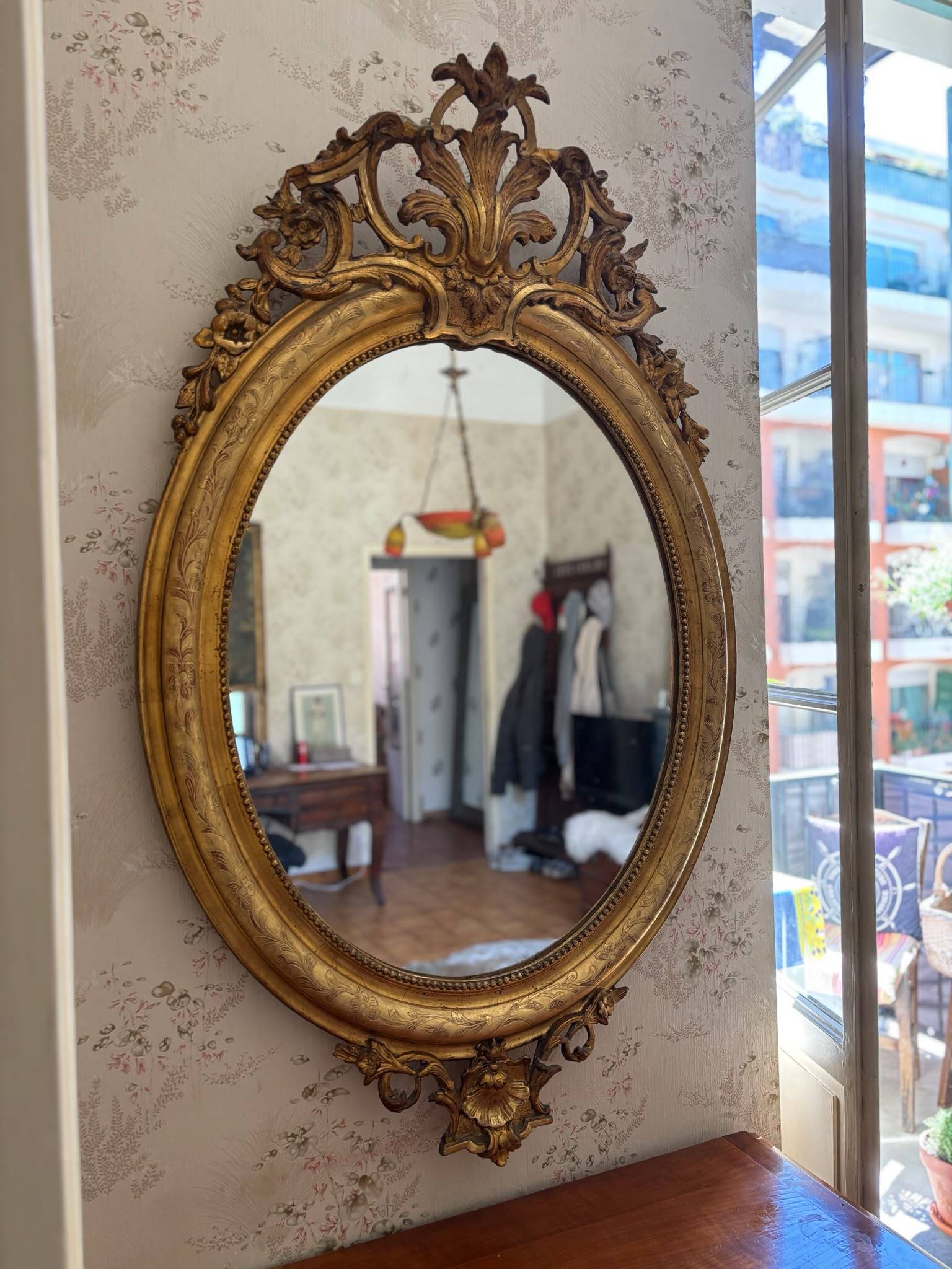 Golden oval mirror