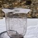 Antique Art Deco engraved glass, silvered rim and base.